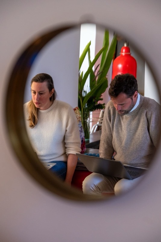 People working together, seen through a round mirror